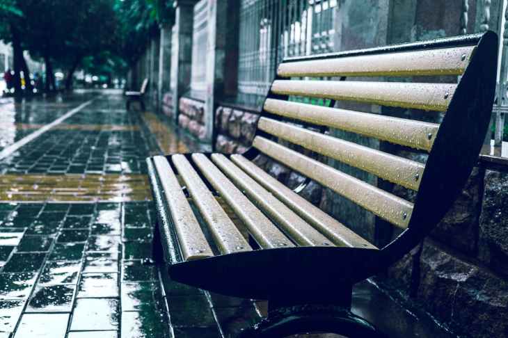 bench empty pavement rain